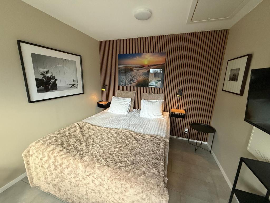 En eller flere senge i et værelse på Stugcentralen Lägenhetshotell & Stugor