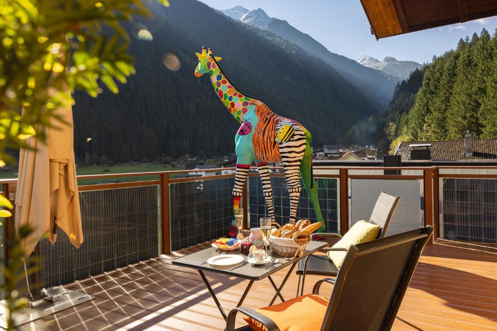 a statue of a giraffe standing on a balcony at Art-Apartments Kartnaller superior in Neustift im Stubaital