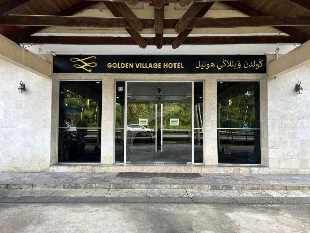 a building with a sign for a hotel at Golden Village Hotel 