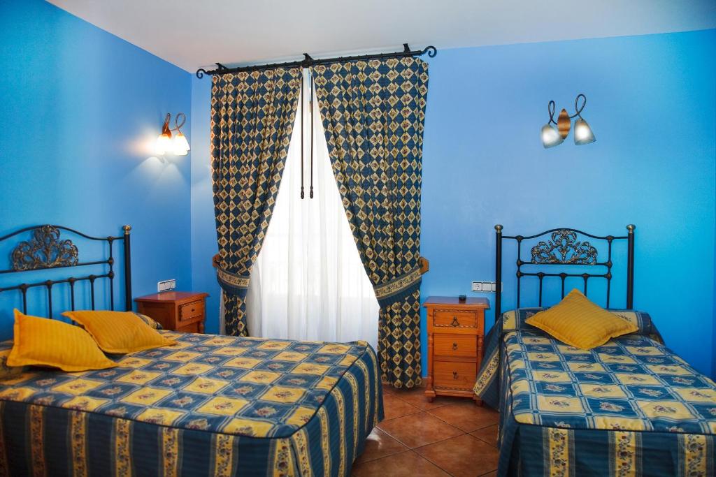 Postel nebo postele na pokoji v ubytování Antiguo Casino de los Arribes