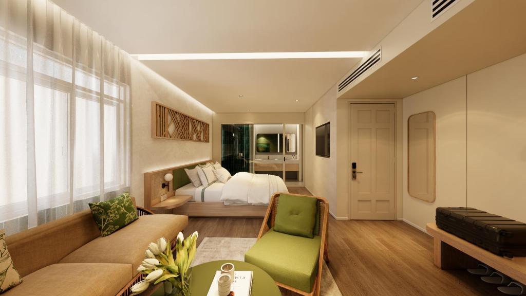a large living room with a bed and a couch at NiK Hotel Nguyen Trai in Ho Chi Minh City