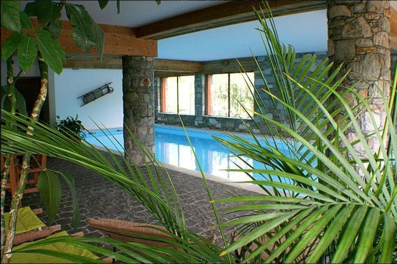 a house with a swimming pool in the middle at Hotel Autantic in Bourg-Saint-Maurice