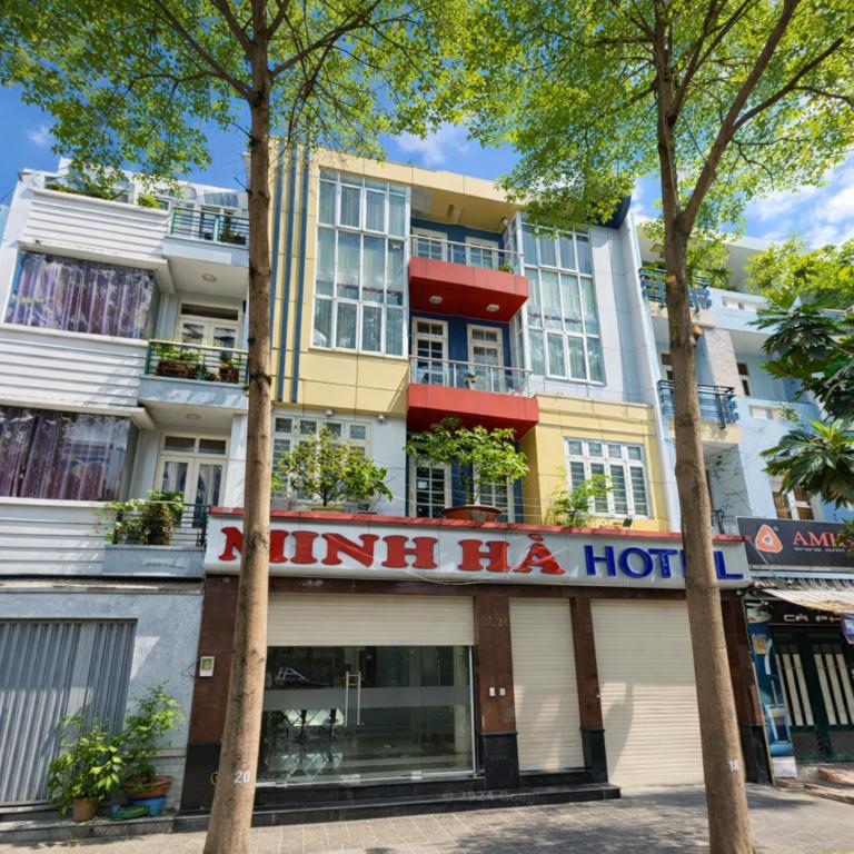 a hotel with a hotel sign in front of a building at Minh Hà Hotel Hồ Chí Minh in Ho Chi Minh City