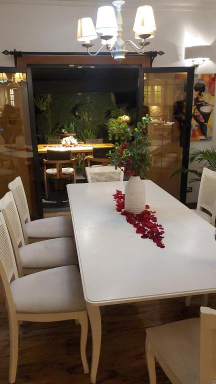a white table and chairs with a plant on it at Luxury Villas in Gakuo
