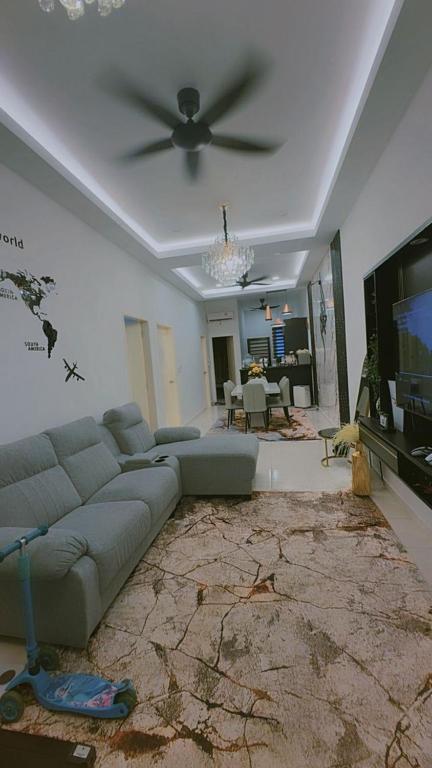 a living room with a couch and a ceiling fan at NFF Homestay Sendayan Seremban in Labu