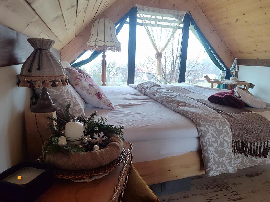 a bedroom with a bed in a room with windows at Pod Aniołem 2 in Dobków