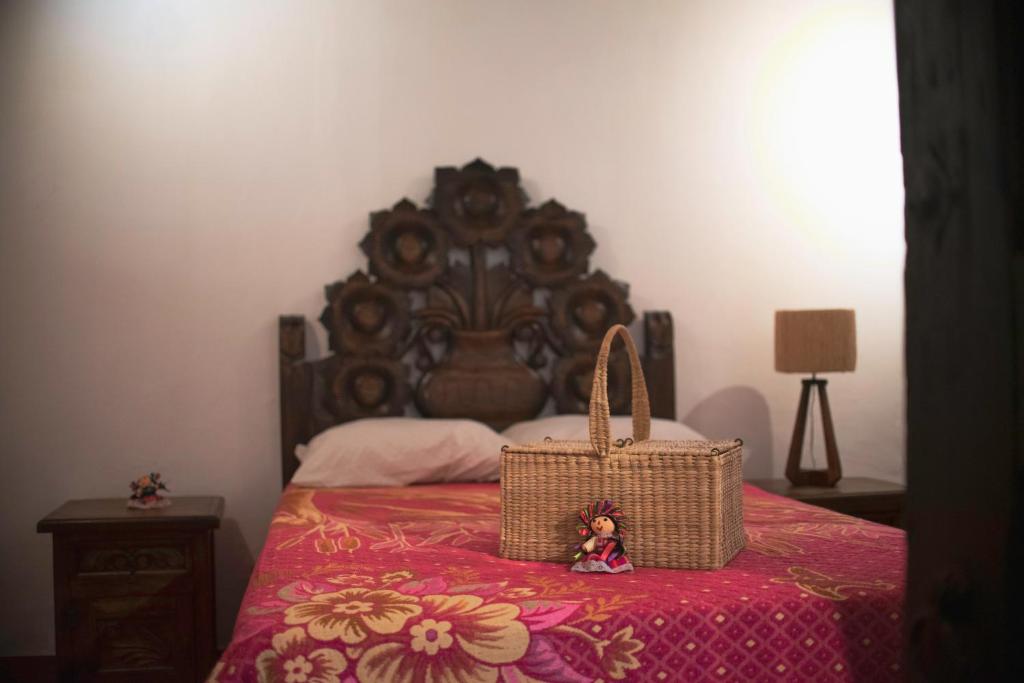 a bedroom with a bed with a basket on a table at Casa Palomar in Guanajuato