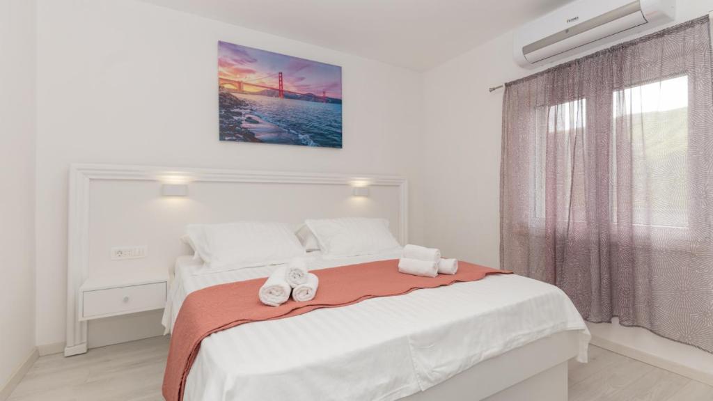 a bedroom with a bed with two towels on it at Star Hill - Makarska by Villas Guide in Slivno