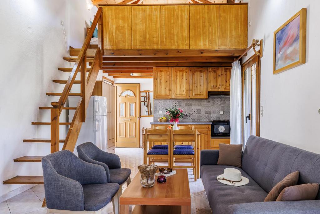 a living room with a couch and a kitchen at Studios Galini in Skopelos Town