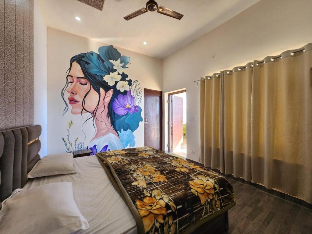 a bedroom with a painting of a woman on the wall at Perry's Cottage in Faigul