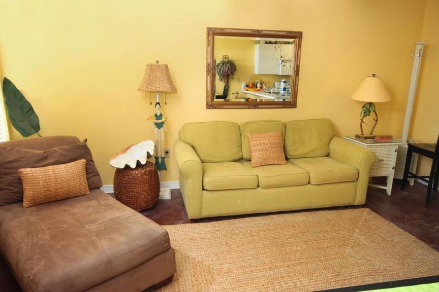 a living room with a couch and a mirror at Grand Beach Resort Unit 106 in Gulf Shores