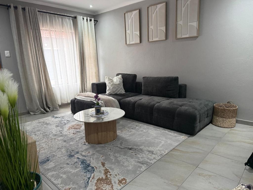 a living room with a couch and a coffee table at Cozzy home in Polokwane