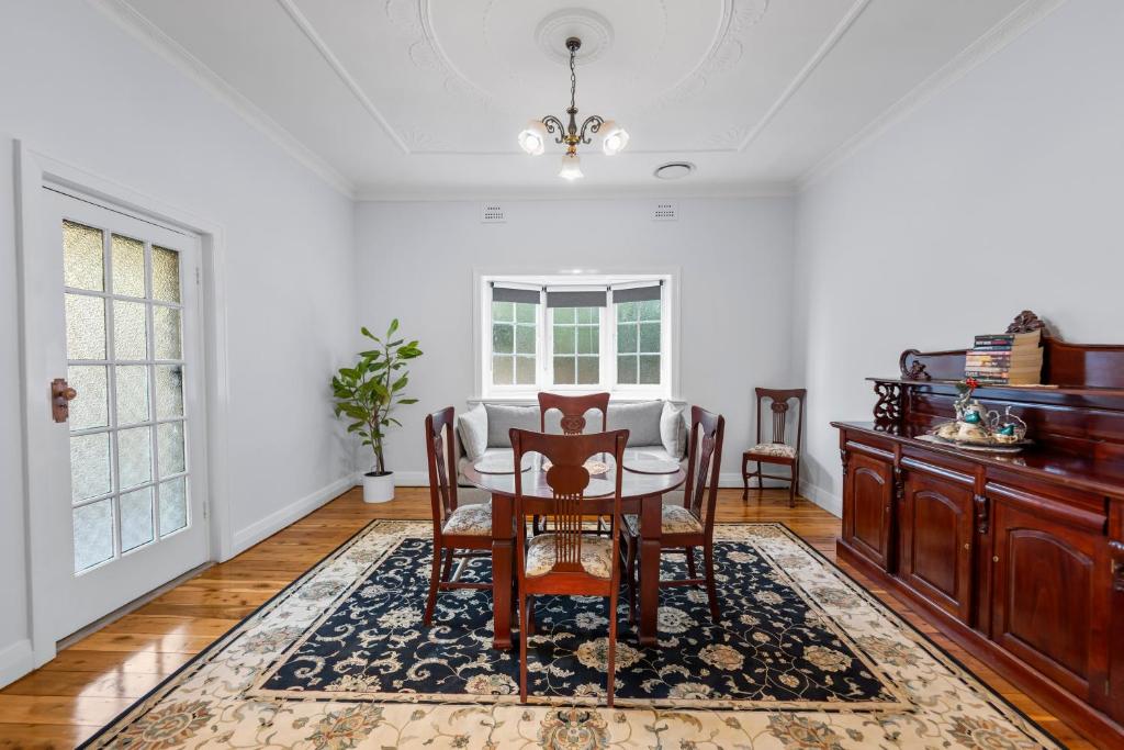 a dining room with a table and chairs at Cottage on Carthage in Tamworth