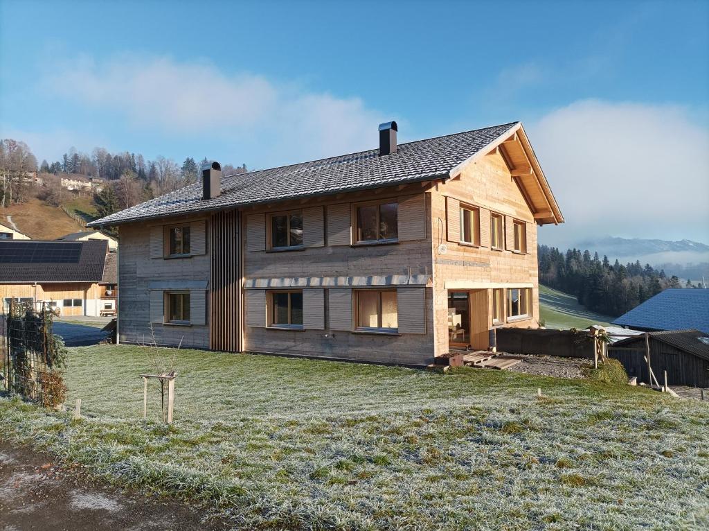 a house sitting on top of a grass field at Ferienwohnung Flatz in Egg
