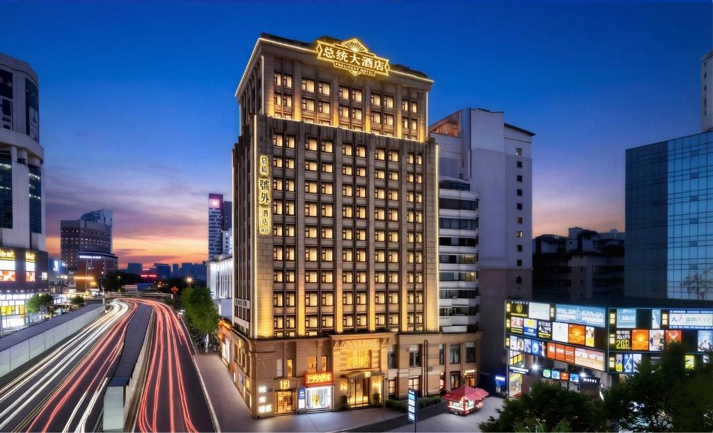 a tall building with a hotel sign on top of it at 总统號外酒店 President HaoWai Hotel Guangzhou in Guangzhou