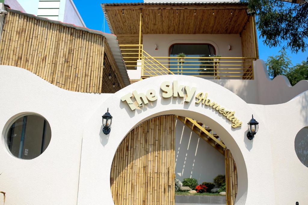 a building with a sign that reads the sky symphony at The Sky Homestay in Ấp Khánh Phước (1)