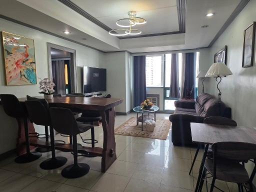 a living room with a table and a couch at Robinsons Place Residences Tower 1 in Sampong