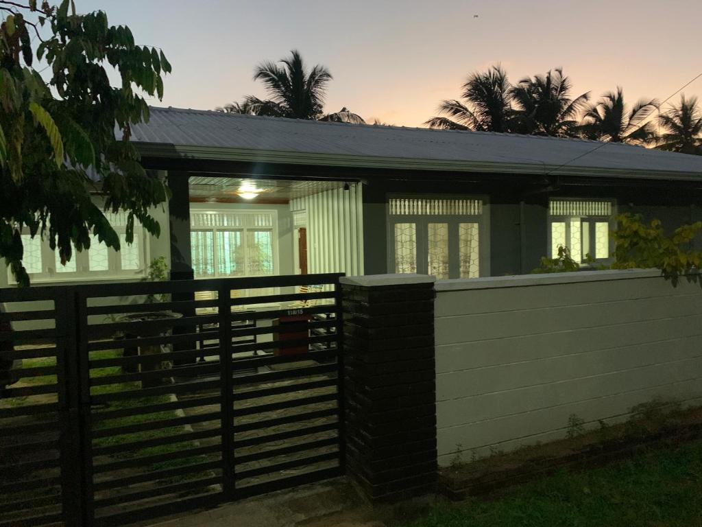 a house with a fence in front of it at JHome in Kurunegala