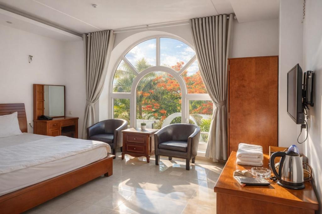 En eller flere senge i et værelse på Mio Hotel Vũng Tàu