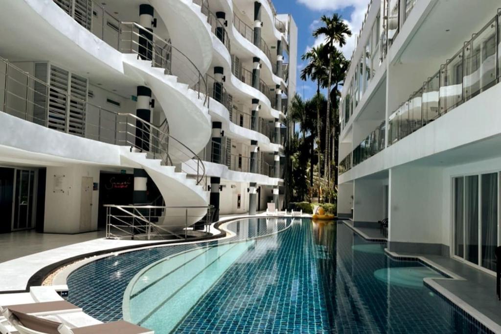 a swimming pool in the middle of a building at Sunset Plaza Condominium in Karon Beach
