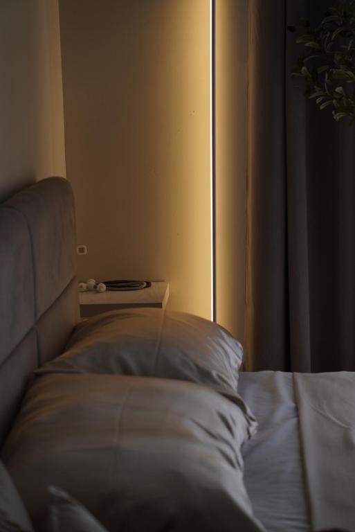 a bedroom with a bed with a pillow and a window at Eden Living - Cebu in Lapu Lapu City