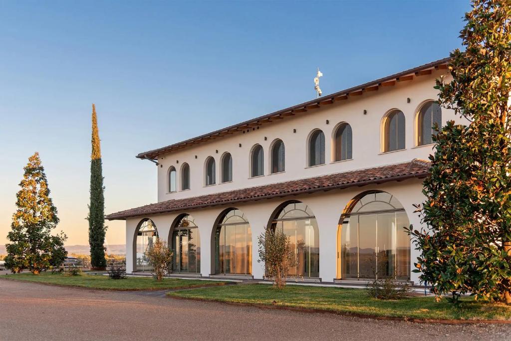a large white building with windows on a street at Tresort Oil Glamping in Principina Terra