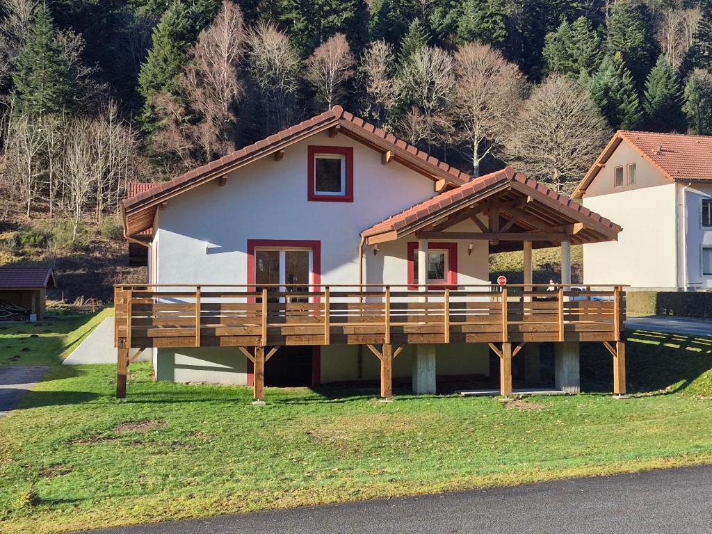 a house with a large deck in front of it at Maison Gite Le Randonneur in La Bresse