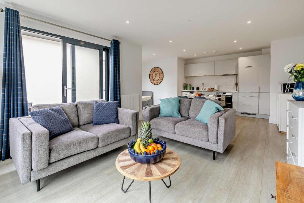 a living room with two couches and a bowl of fruit on a table at 2 Bed in Woolacombe oc-s29469 in Woolacombe