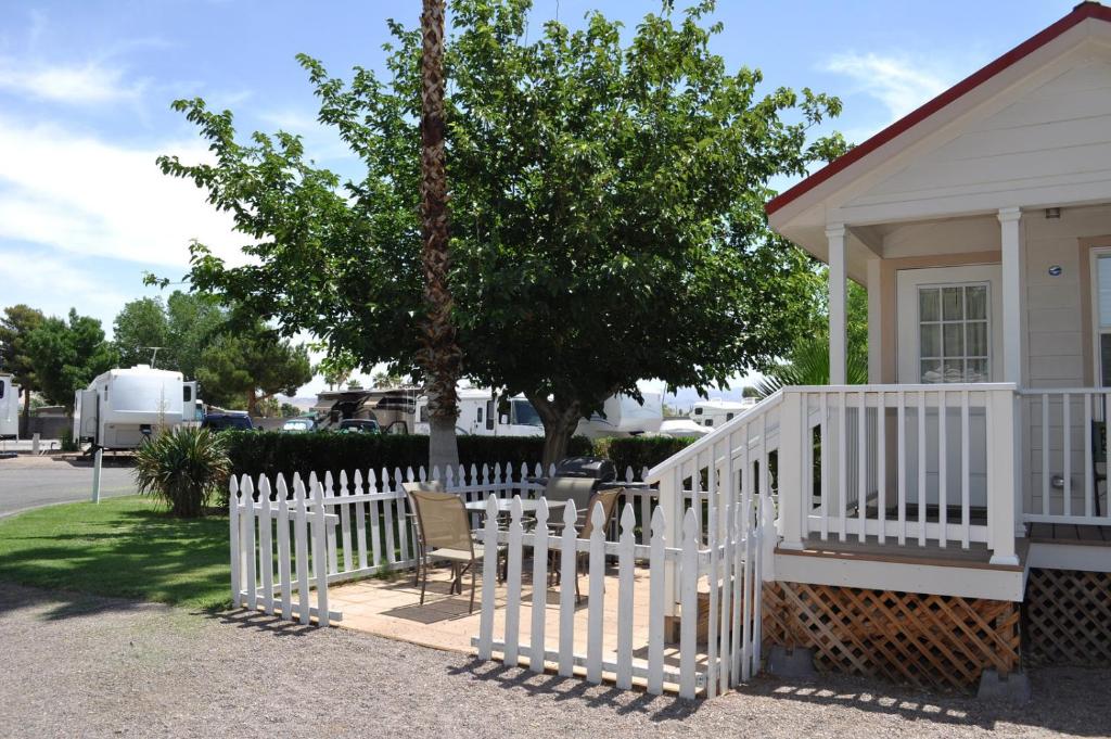 a white fence in front of a house at Las Vegas Camping Resort Cabin 2 in Las Vegas