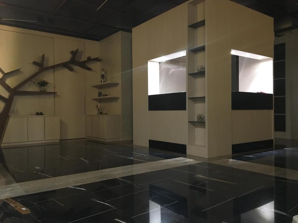 a room with a black tiled floor and shelves at Archeo Hotel in Gela