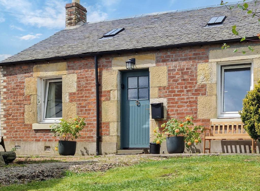 a brick house with a green door and windows at 1 Bed in Errol oc-s33022 in Errol