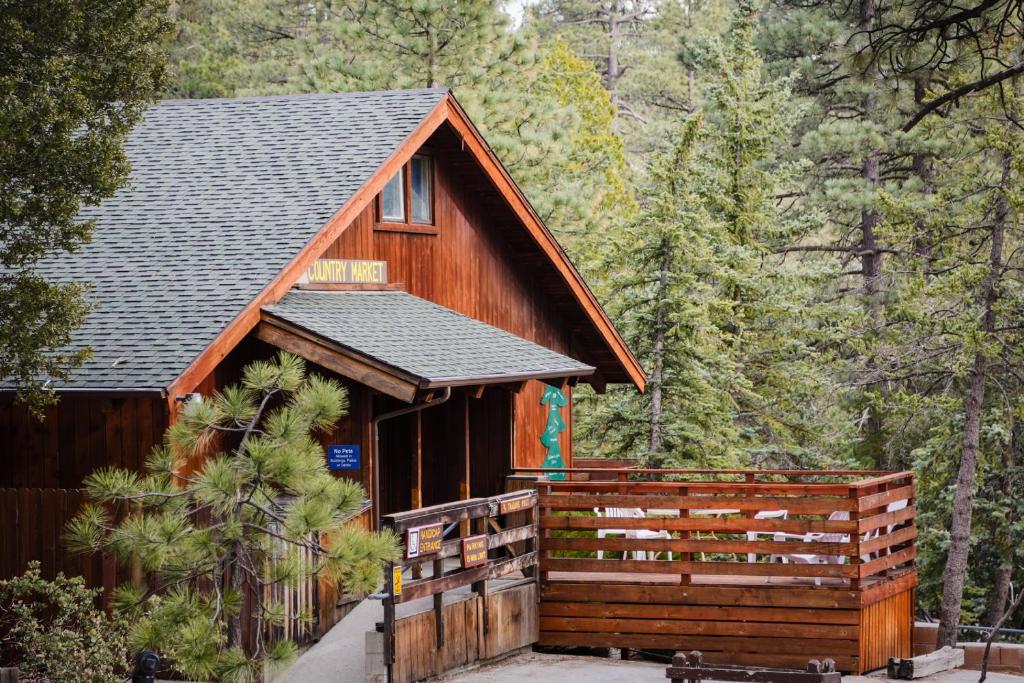 a cabin in the woods with a wooden fence at Idyllwild Camping Resort Wheelchair Accessible Cottage in Idyllwild