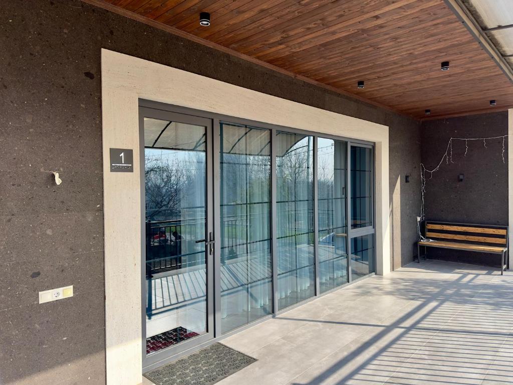 ein leeres Zimmer mit Glastüren an einem Gebäude in der Unterkunft LARTA Rest House in Ashtarak