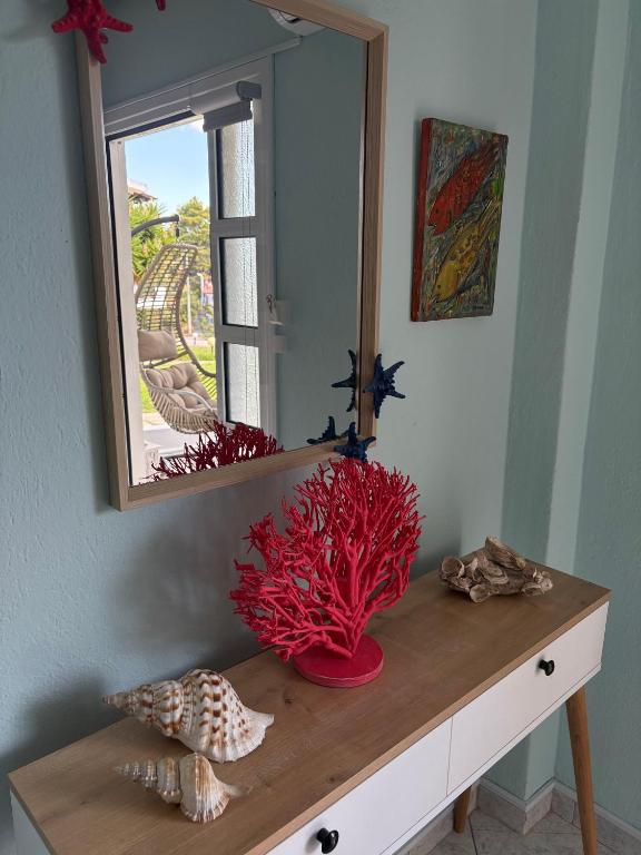 a mirror on top of a dresser in a room at Zoel's House in Chalkidiki in Agia Paraskevi