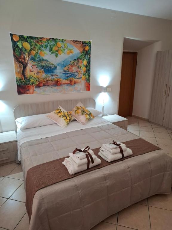 a bedroom with a large bed with towels on it at B&B Le Lumìe " Bed end Kitchen" in Agrigento