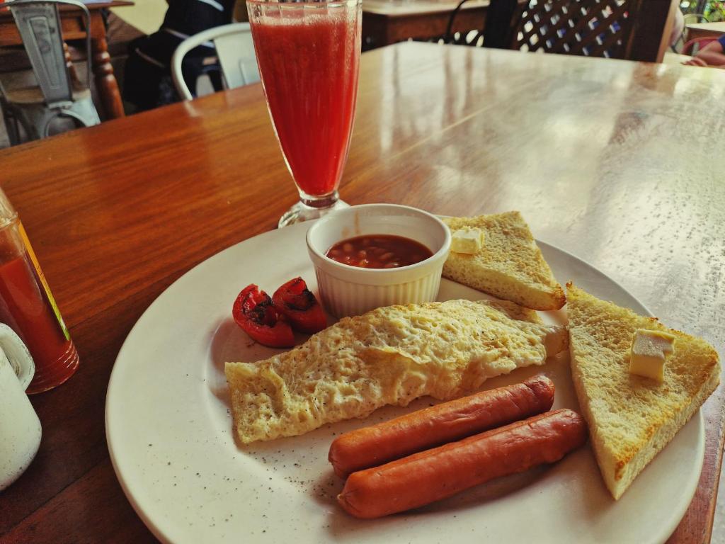 a plate of breakfast food with hot dogs and toast at Stone Town Cafe in Zanzibar City