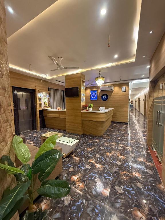 a lobby of a hotel with a reception desk at Hotel Krish villa in Vadodara