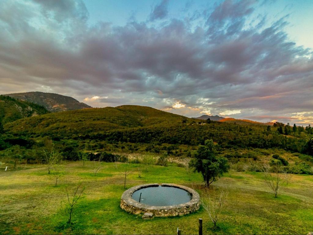 a small pond in the middle of a field at Die Skoolhuisie in Avontuur