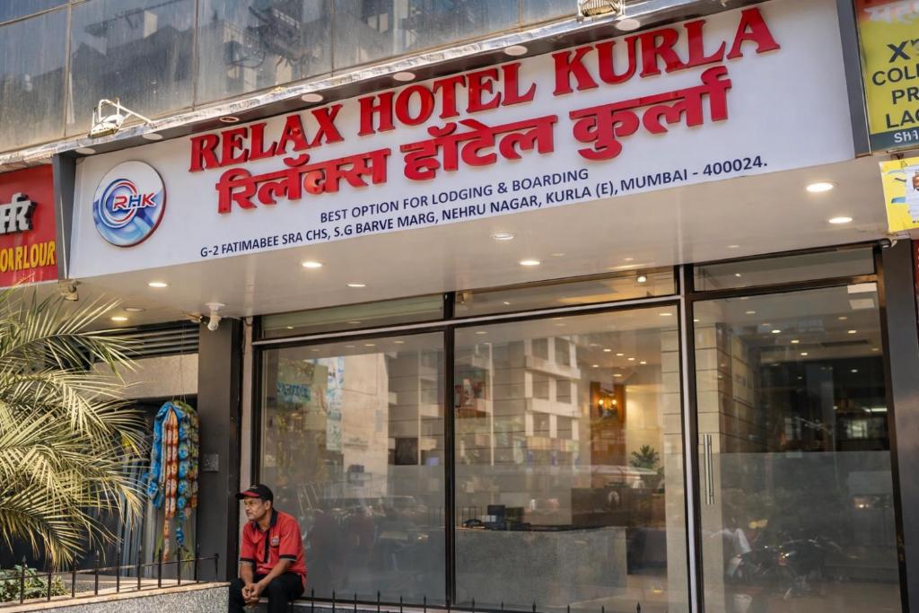 a man standing in front of a hotel kuhilli kuana referral center at Relax Hotel Kurla in Mumbai