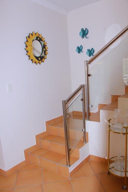a set of stairs with a mirror on the wall at Keke Place in Vila Praia Do Bilene