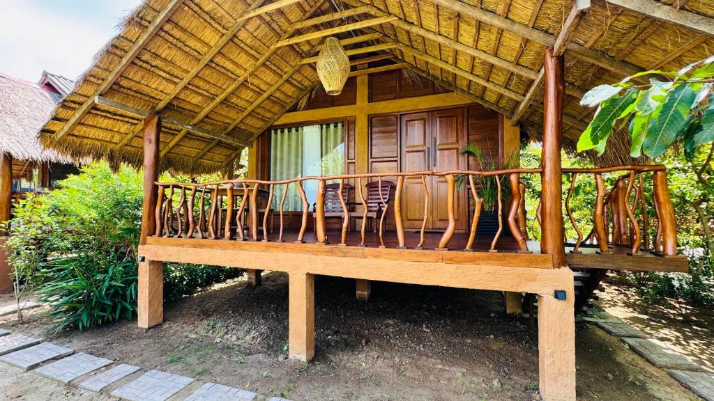 a hut with a deck with chairs in it at Ceylon Elegance Villa in Kurunegala