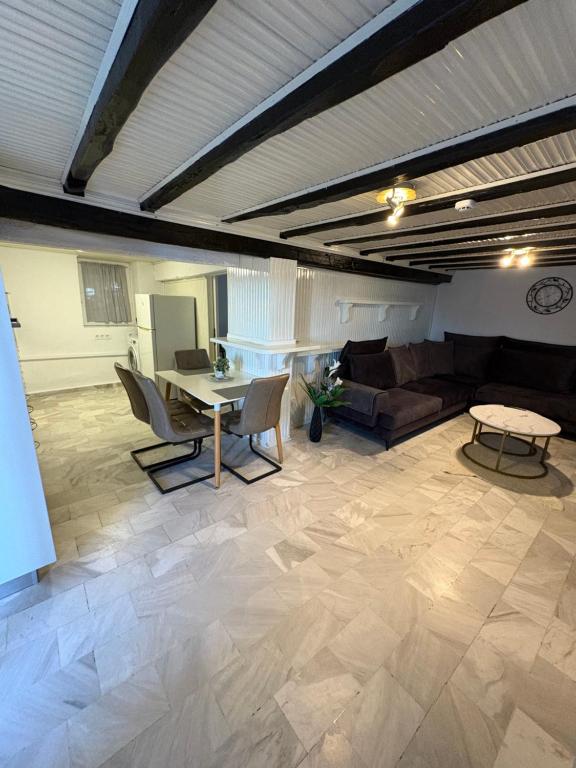 a living room with a couch and a table at Appartment by Eftymia in Nea Roda