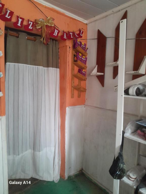 a room with a white curtain and a window at Casa para alugar para o Carnaval in Recife