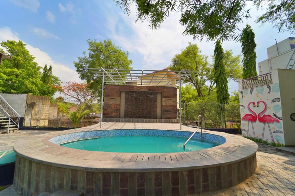 a swimming pool in the middle of a yard at Arpan Villa in Aurangabad
