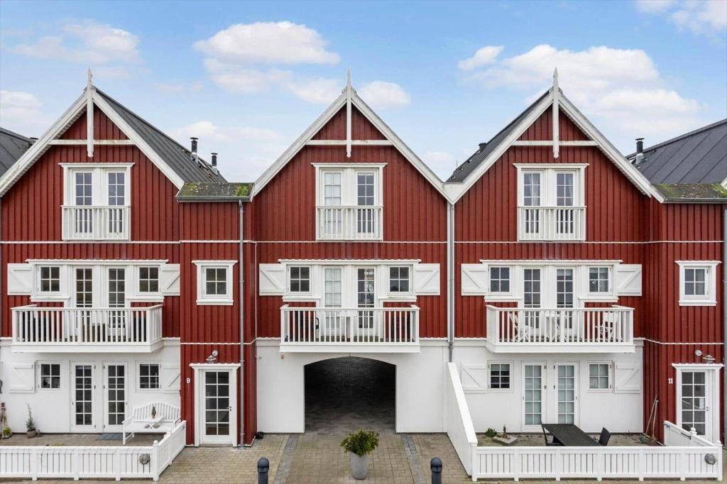 a large red and white building with white windows at LL264-Bagenkop-Faergevej-9-1-th in Bagenkop