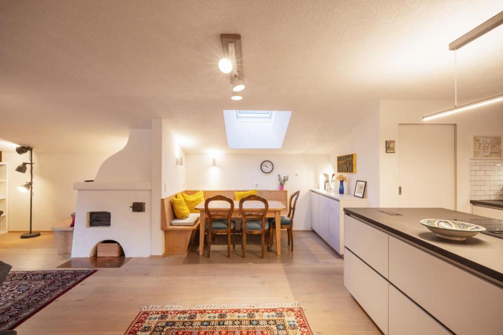 a kitchen and dining room with a table and chairs at Katja's Loft in Neustift im Stubaital