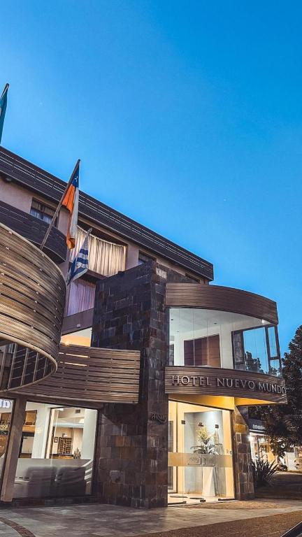 a hotel building with a flag in front of it at Hotel Nuevo Mundo in San Rafael