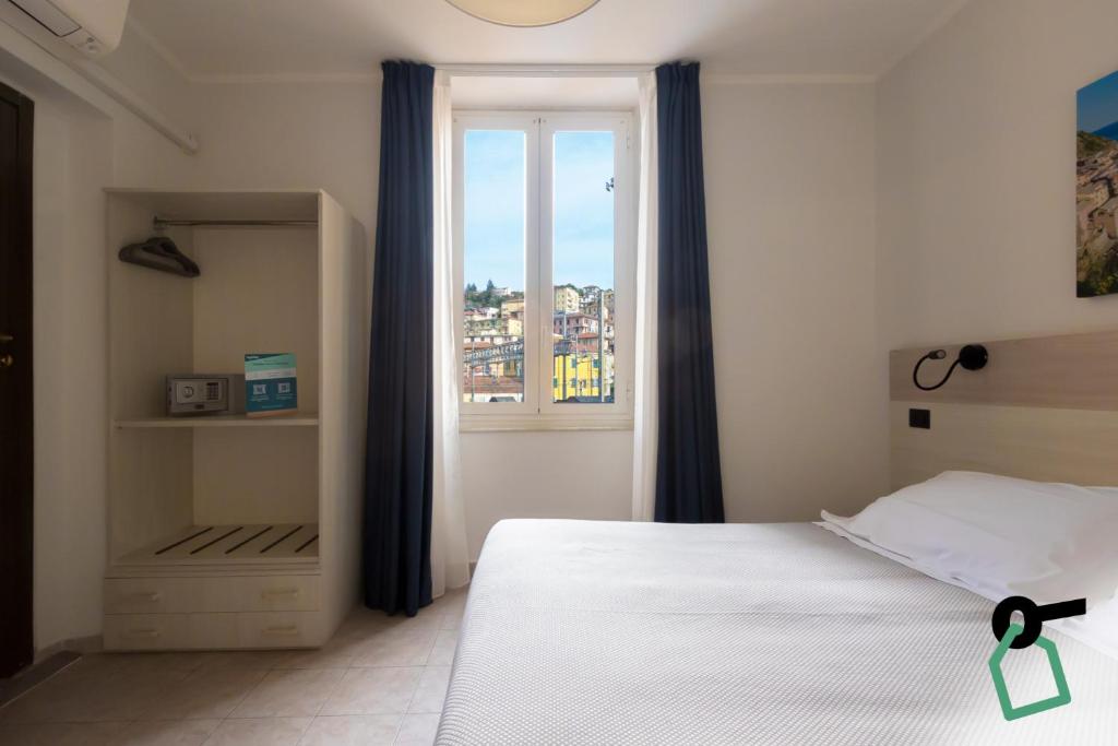 a bedroom with a bed and a window at Hotiday La Spezia Centrale in La Spezia