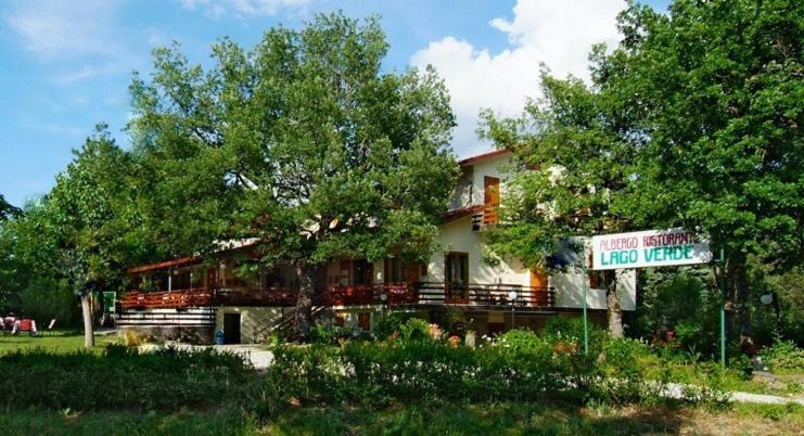 a house with a sign in front of it at Albergo Lago Verde in Pennabilli