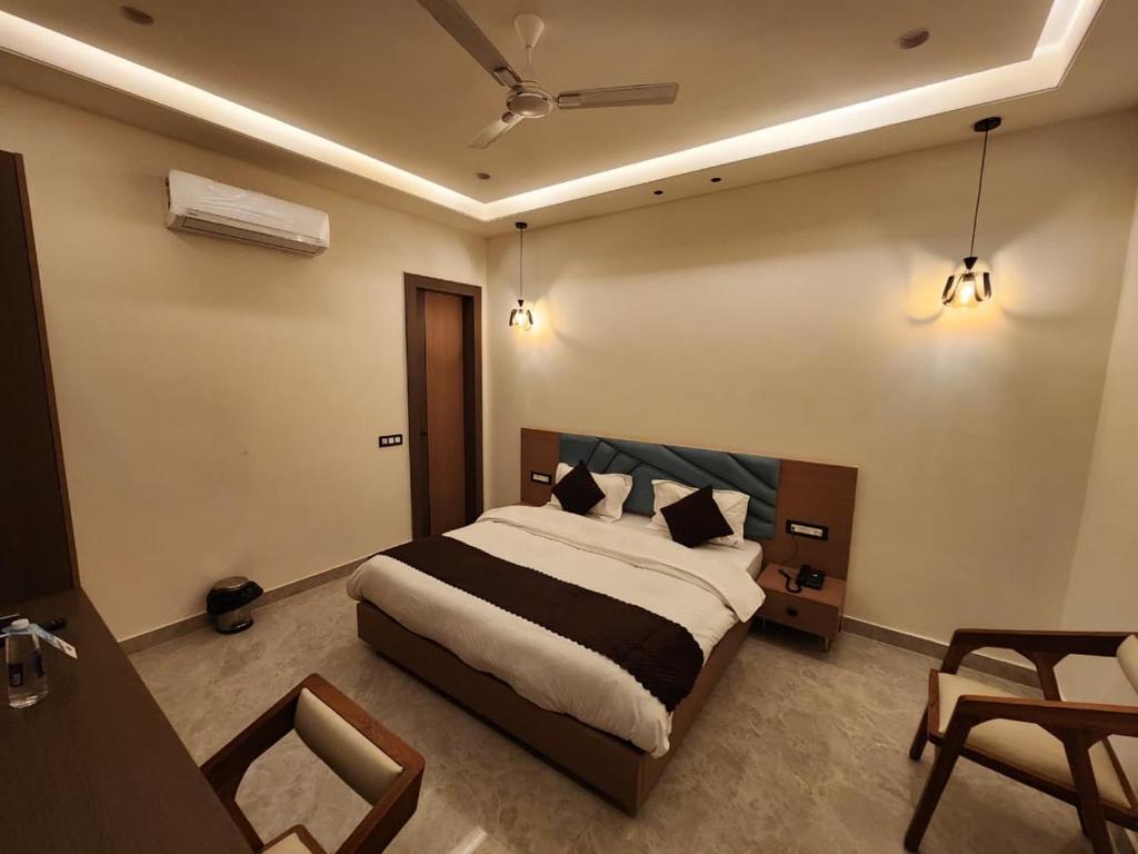 a bedroom with a large bed in a room at Den Inn in Hisār